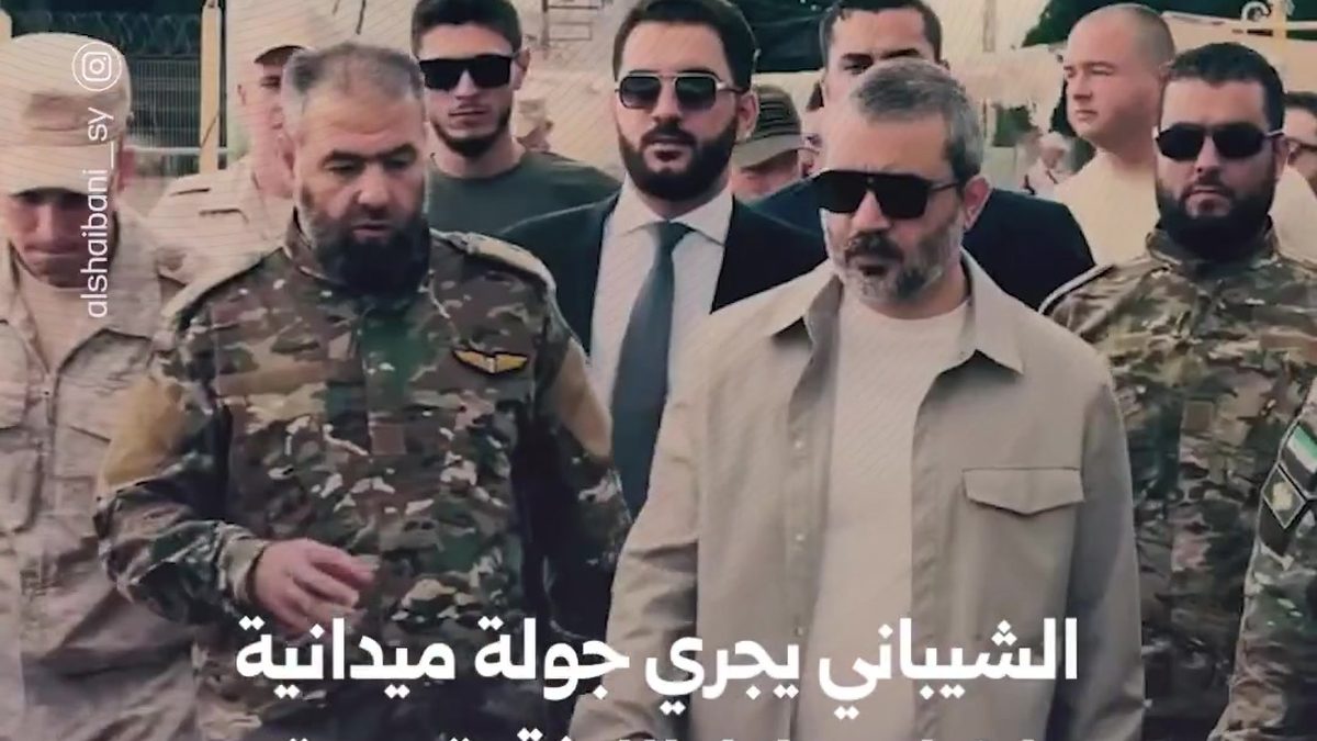 An official Syrian delegation walking through Latakia airport facilities accompanied by military officials