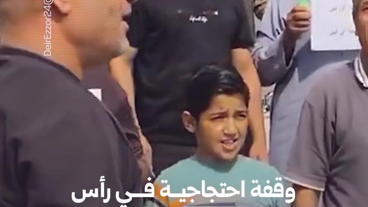 Residents participating in a peaceful protest stand-in in the city of Ras al-Ain raising demands for full Syrian state sovereignty